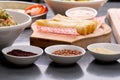 Close up shot of sumac, lentil and quinoa seeds with cheese rolls and salad in the background