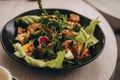 Close up shot of summer salad bowl with wooden table background Royalty Free Stock Photo