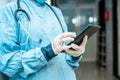 Close up shot of surgeon hands using smart tablet at hospital corridor - concept of checking reports, technologyand Royalty Free Stock Photo