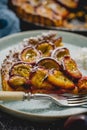 Close up shot of a sweet plum pie piece served on a plate