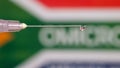 Close up shot of syringe with droplet , see through of South Africa flag with new COVID variant Royalty Free Stock Photo