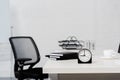 close-up shot of table with stack of notebooks and alarm clock