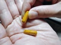 Taking Medication Capsules from Palm of Hand