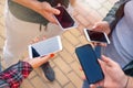 Close up shot of teenager group of people using their phones outdoor Royalty Free Stock Photo