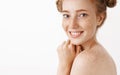 Close-up shot of tender and feminine good-looking ginger female standing naked in profile turning at camera with happy Royalty Free Stock Photo