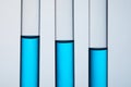 close-up shot of test tubes filled with blue liquid in row Royalty Free Stock Photo