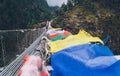 Close up shot of Tibetan multicolored Prayer flags on the Suspension Bridge hinged over gorge.  Everest Base Camp EBC trekking Royalty Free Stock Photo