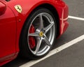 Close-up shot of the tire of the luxury Italian red Ferrari in the parking place