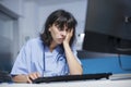 Tired woman using desktop pc in clinic Royalty Free Stock Photo