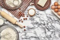 Close-up shot. Top view of a baking ingredients and kitchenware on the marble table background. Royalty Free Stock Photo