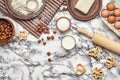 Close-up shot. Top view of a baking ingredients and kitchenware on the marble table background. Royalty Free Stock Photo