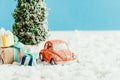 close-up shot of toy car with presents and christmas tree standing on snow made of cotton