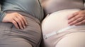 Close up of an overweight two women in tight clothes., plus size female waistline, belly, body positivity