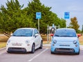 Close up shot of two Fiat 500e charging at the station