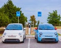 Close up shot of two Fiat 500e charging at the station