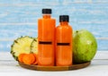 Close up shot of two tasty healthy orange drink mixed fruits and vegetable juice bottles with no brand for commercial Royalty Free Stock Photo