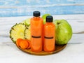 Close up shot of two tasty healthy orange drink mixed fruits and vegetable juice bottles with no brand for commercial Royalty Free Stock Photo