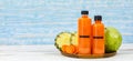 Close up shot of two tasty healthy orange drink mixed fruits and vegetable juice bottles with no brand for commercial Royalty Free Stock Photo