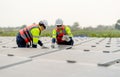 Close up shot of two technician workers sit and work on process of maintenance solar cell panel network system in concept of green Royalty Free Stock Photo