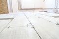 Close up shot of unfinished floor tiles installation in kitchen Royalty Free Stock Photo