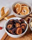 Close-up shot of a variety of dried sweet fruits arranged in bowls