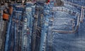 Close up shot of various blue Jeans on a hanging rack in the clothes store. Shopping and clothing store concepts Royalty Free Stock Photo