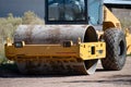 Close up shot of vibrating soil compacting roller machine at work Royalty Free Stock Photo