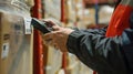 A close-up shot of a warehouse worker using a handheld barcode