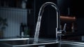 Close-up shot of water tap in modern luxury kitchen. Metal sink, chrome faucet with running water. Beautiful dramatic Royalty Free Stock Photo