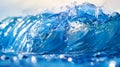 Close-up shot of a water wave in bright blue color