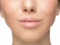 Close up shot of well-kept female big lips and cheeks on white studio background