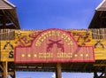 Close-up shot of the Western City park entry board with a revolver logo with background of sky.