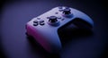 Close up shot of a white gaming controller with black buttons on a dark purple surface in dim lighting Royalty Free Stock Photo