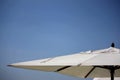 Close-up shot of the white parasols. Royalty Free Stock Photo