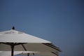 Close-up shot of the white parasols. Royalty Free Stock Photo