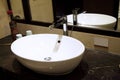 Close-up shot of white washbasin in bathroom. Royalty Free Stock Photo