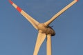 Close-up shot of a wind turbine, producing renewable energy on a blue sky background Royalty Free Stock Photo