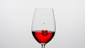 Close up shot of wine glass isolated on white background in studio. Goblet filled with red wine, droplets of wine Royalty Free Stock Photo