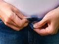 A close-up shot of a woman buttoning jeans Royalty Free Stock Photo