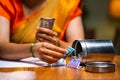 Close up shot of woman counting money by taking from steel box for monthly expenses at home - concept of savings Royalty Free Stock Photo