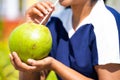 Close up shot of woman drinking coconut water during summer at park after morning walk or jog - concept of refreshment Royalty Free Stock Photo