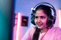 Close up shot of woman gamer live streaming video game by talking on headphones at home - concept of hobbyist Royalty Free Stock Photo