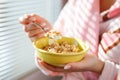 A close up shot of a woman holding a bowl of cereal Royalty Free Stock Photo