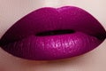 Close-up shot of woman lips with glossy fuchsia lipstick. Perfec