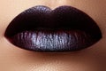 Close-up shot of woman lips with glossy plum lipstick. Perfect p