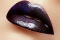 Close-up shot of woman lips with glossy plum lipstick. Perfect p