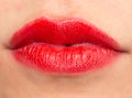 Close-up shot of woman lips with glossy red lipstick Royalty Free Stock Photo