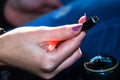 Close up shot of a woman`s hand holding an usb cable in her car Royalty Free Stock Photo