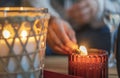 Close-up shot of a woman`s hand lighting candle using matches Royalty Free Stock Photo