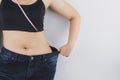 Close up shot of woman with slim body measuring her waistline and torso. Healthy nutrition, diet and weight losing concept Royalty Free Stock Photo